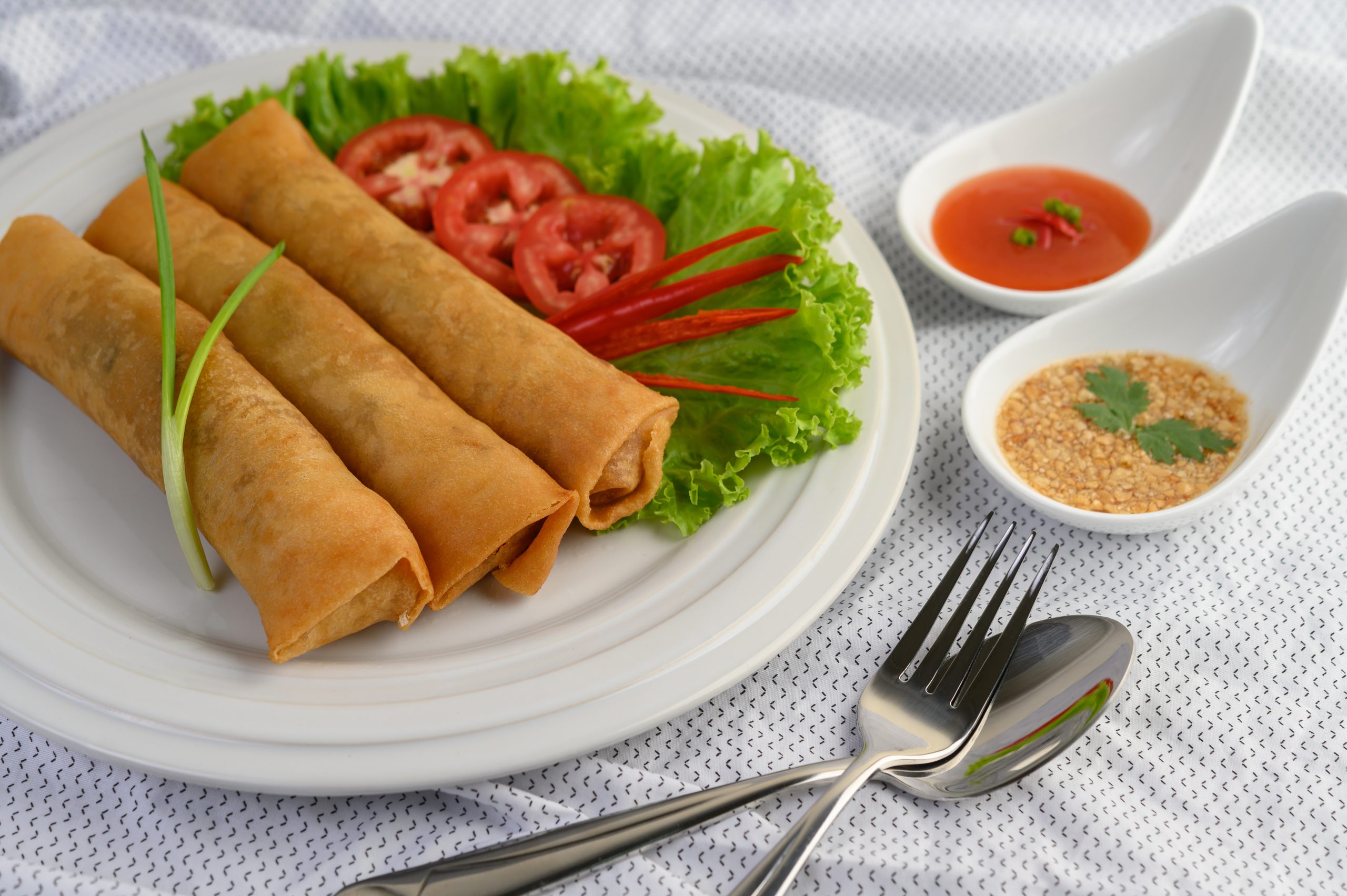 Crispy spring rolls with sauces.