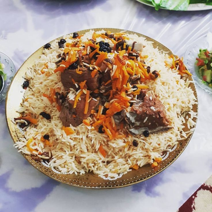 Traditional Afghan Kabuli Pulao served with tender meat and carrots